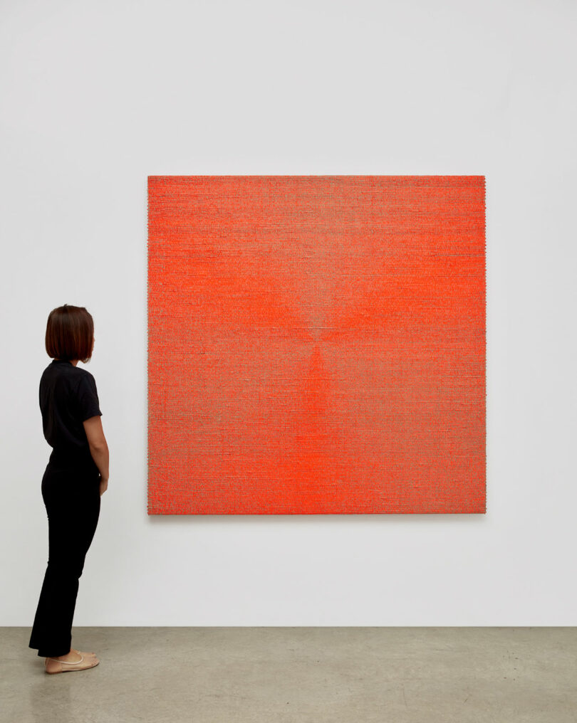 viewer with large square orange painting