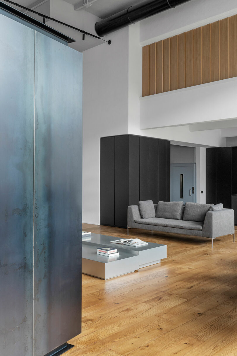 Angled interior shot of modern industrial loft showing living room and kitchen