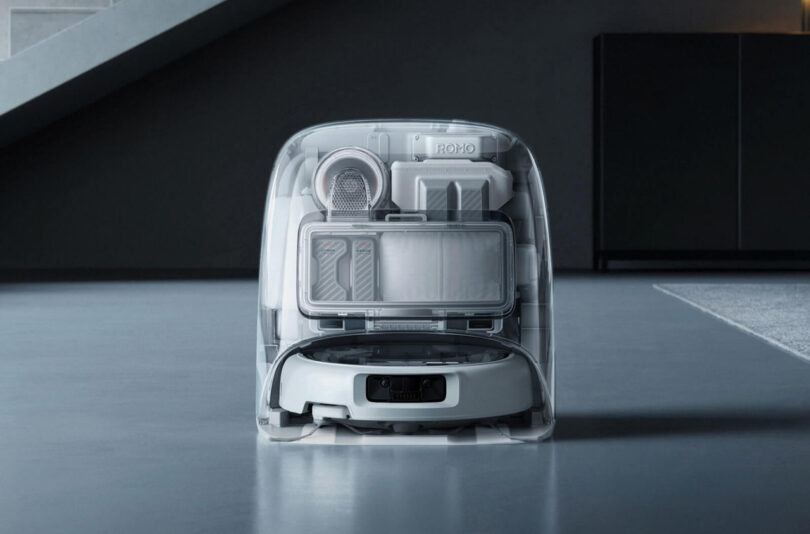 A robotic vacuum cleaner, inspired by DJI Romo technology, docked at its charging station, is shown with a transparent view revealing internal components and cleaning tools.