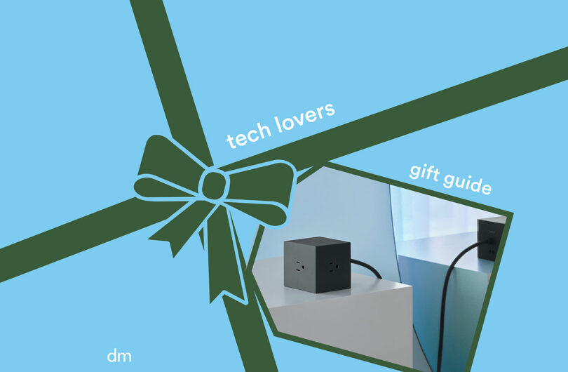 A blue background with a dark green ribbon graphic labeled "tech lovers gift guide," featuring a photo of a black power cube on a white surface—perfect for curated gift guides.