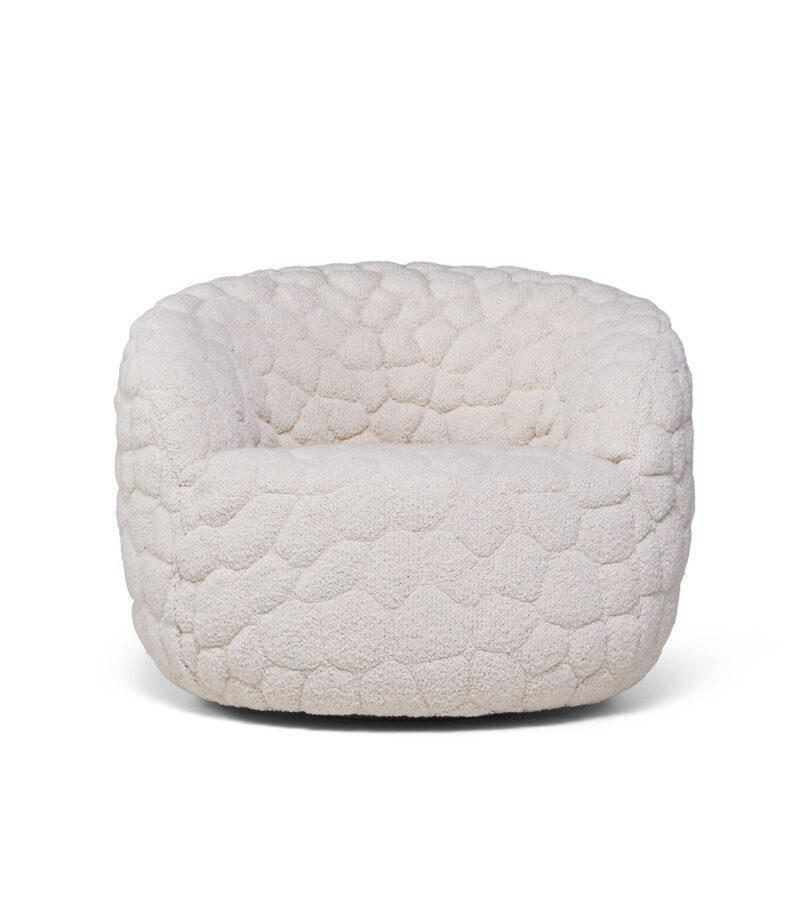 A white, textured, rounded armchair with a quilted pattern and a low, wide seat, viewed from the front against a plain background.