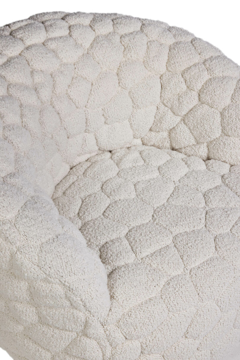 A white chair with a white cushion.