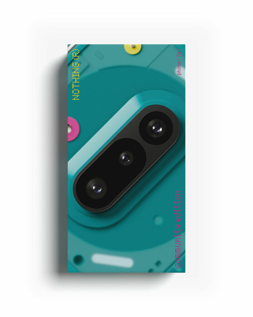 Rectangular package with a teal background, featuring a graphic of a three-lens camera module and small colorful shapes; text is printed along the edges.