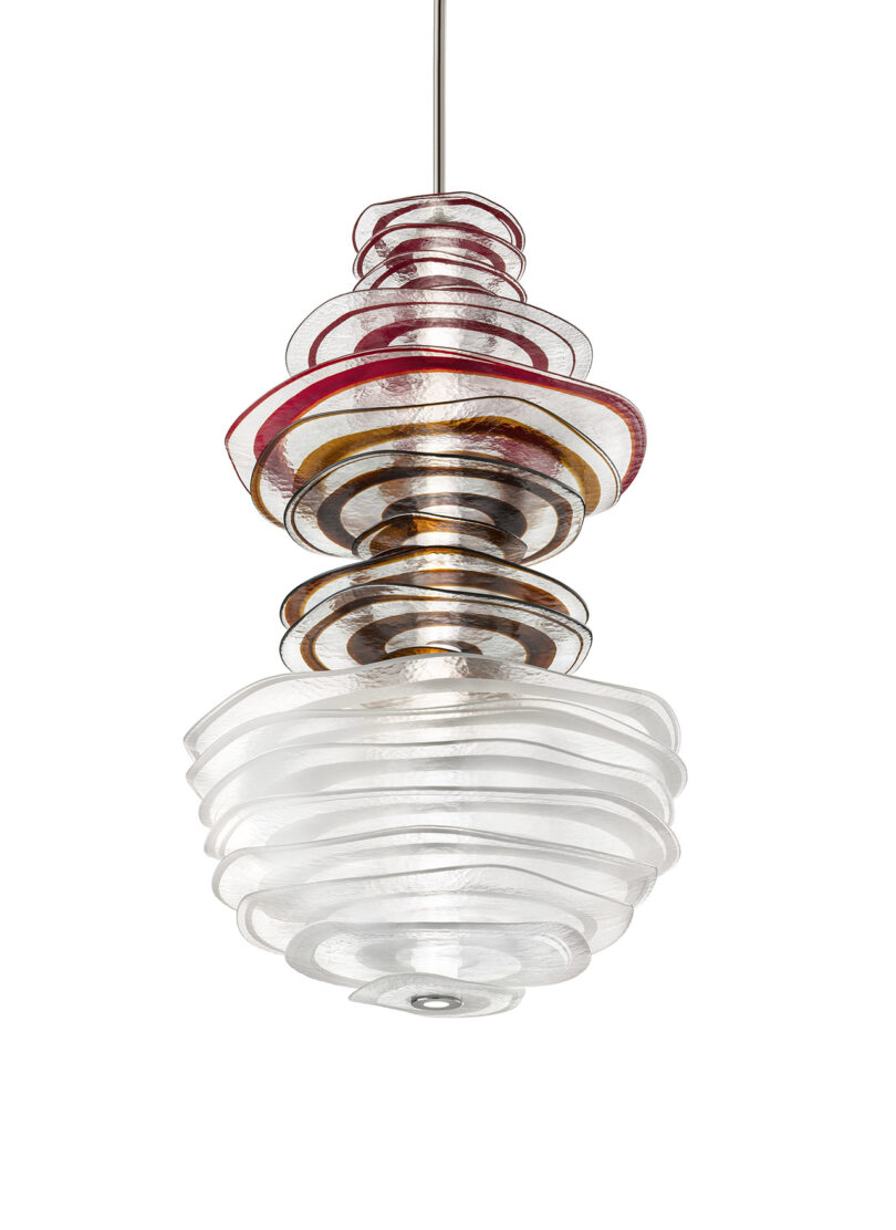 A modern pendant light fixture with layered, wavy glass discs in clear, amber, and red tones, suspended by a thin metal rod.