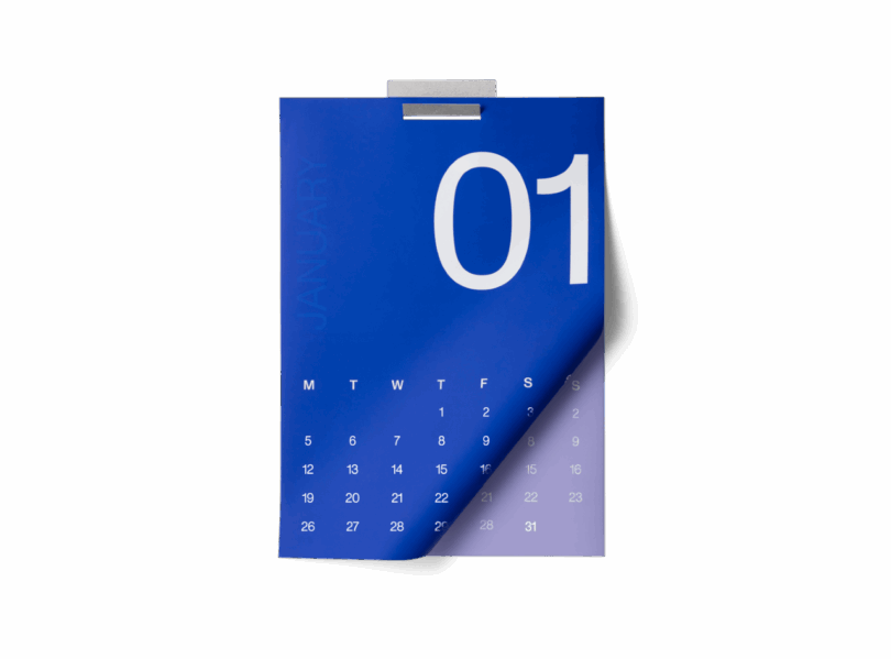 A blue wall calendar turned to January 1st, with days of the month displayed in white text and a metal clip at the top